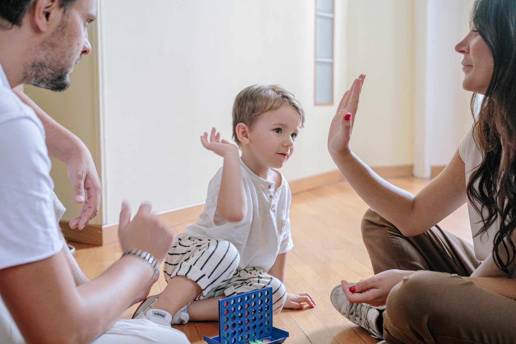 Child Playing with Parents at Home